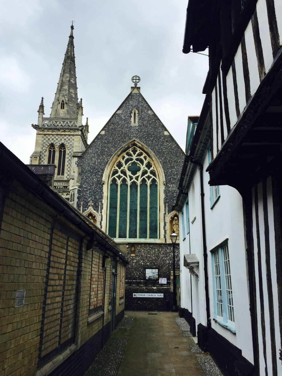 An old church looms above a narrow alleyway